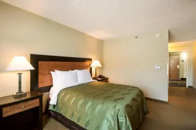 a hotel room with a bed and two lamps at Chester Hotel and Conference Center in Exton