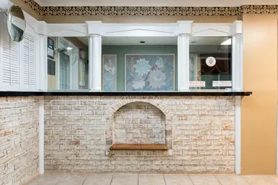 a brick wall with a window on top of it at Knights Inn Palmyra in Palmyra