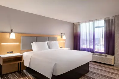 a hotel room with a large bed and a window at Holiday Inn Philadelphia Arpt-Stadium Area by IHG in Philadelphia
