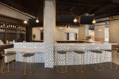a bar in a restaurant with stools and a counter at Holiday Inn Philadelphia Arpt-Stadium Area by IHG in Philadelphia