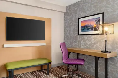 a room with a desk and a tv and a chair at Holiday Inn Philadelphia Arpt-Stadium Area by IHG in Philadelphia