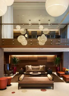 a living room with a couch and chairs at The Pearl Hotel in New York