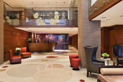 a lobby of a hotel with chairs and a table at The Pearl Hotel in New York