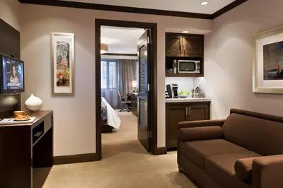 a living room with a couch and a kitchen at The Pearl Hotel in New York