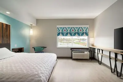a hotel room with a bed and a window at Tru By Hilton York Pa in York