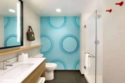 a bathroom with a toilet and a shower at Tru By Hilton York Pa in York