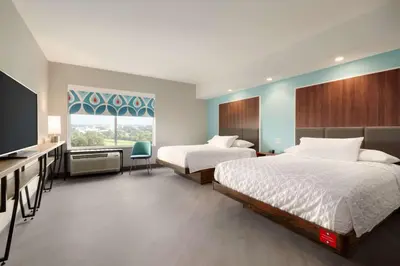 a hotel room with two beds and a flat screen tv at Tru By Hilton York Pa in York