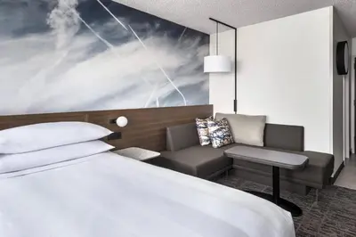 a hotel room with a bed and a couch at Newark Liberty International Airport Marriott in Newark