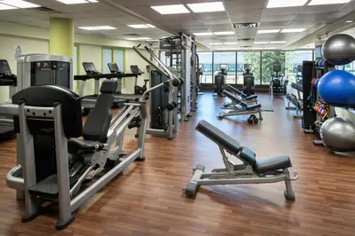 a gym with several treadmills and exercise machines at Newark Liberty International Airport Marriott in Newark