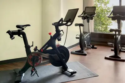 a gym with three exercise bikes and a treadmill at Newark Liberty International Airport Marriott in Newark