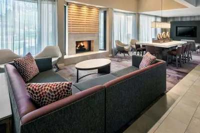 a living room with a couch and a fireplace at Courtyard Newark Liberty International Airport in Newark