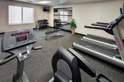 a gym with cardio equipment and treadmills in a room at Courtyard Newark Liberty International Airport in Newark