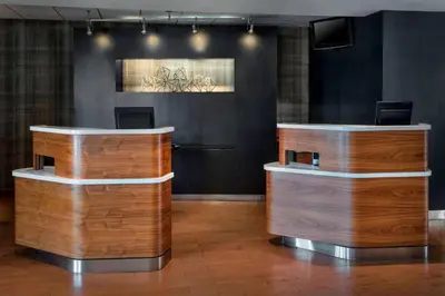 a lobby with two wooden counter tops in a room at Courtyard Newark Liberty International Airport in Newark