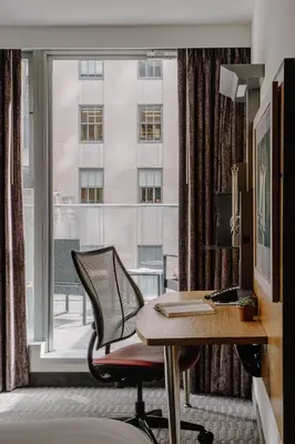 an office with a desk and a chair and a window at The Jewel Hotel, New York in New York