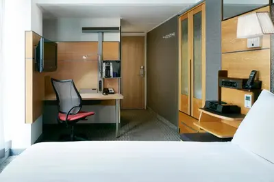 a hotel room with a bed and a desk and a chair at The Jewel Hotel, New York in New York
