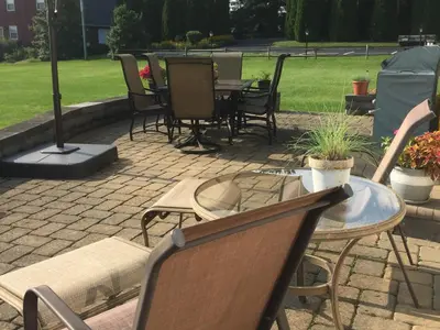 a patio with chairs and a table and a table and chairs at Homestead Lodging in Smoketown