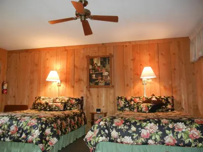 a bedroom with two beds and a ceiling fan at Homestead Lodging in Smoketown