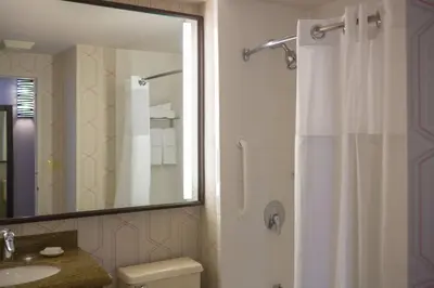 a bathroom with a shower and a toilet and a sink at Courtyard by Marriott New York Manhattan/ Fifth Avenue in New York