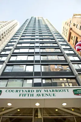a tall building with a sign on the side of it at Courtyard by Marriott New York Manhattan/ Fifth Avenue in New York