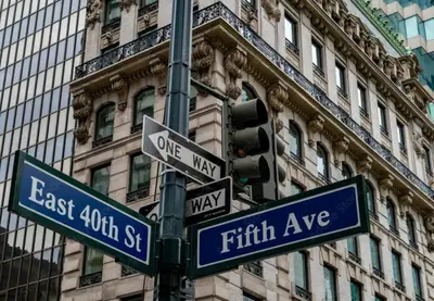 a traffic light with street signs on a pole at Courtyard by Marriott New York Manhattan/ Fifth Avenue in New York