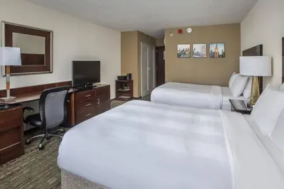 a hotel room with two beds and a desk with a computer at Philadelphia Airport Marriott in Philadelphia