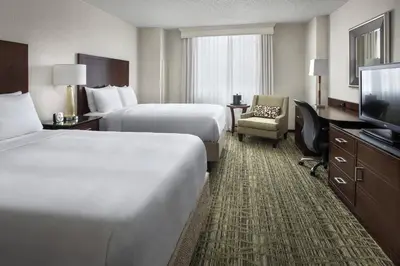a hotel room with two beds and a flat screen tv at Philadelphia Airport Marriott in Philadelphia