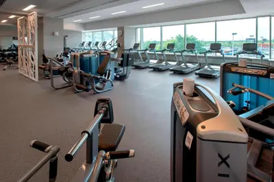 a gym with rows of treadmills and machines at Philadelphia Airport Marriott in Philadelphia