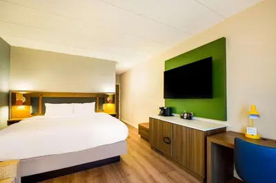 a hotel room with a bed and a flat screen tv at Sonesta Select Philadelphia Airport in Philadelphia