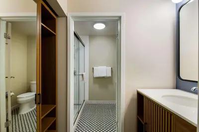 a bathroom with a shower and a toilet and a sink at Sonesta Select Philadelphia Airport in Philadelphia