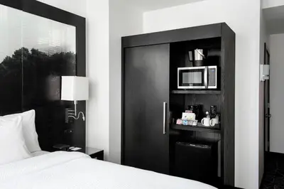 a bedroom with a bed and a black door with a microwave at Residence Inn by Marriott Philadelphia Center City in Philadelphia