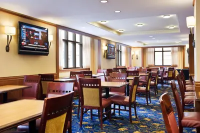 a restaurant with tables and chairs and a tv on the wall at Residence Inn by Marriott Philadelphia Center City in Philadelphia