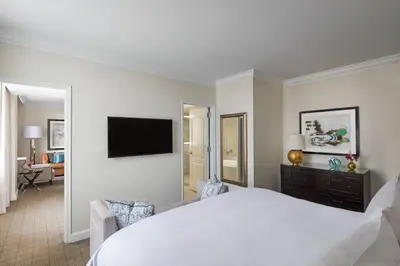 a white bedroom with a large bed and a television at The Ritz-Carlton, Philadelphia in Philadelphia