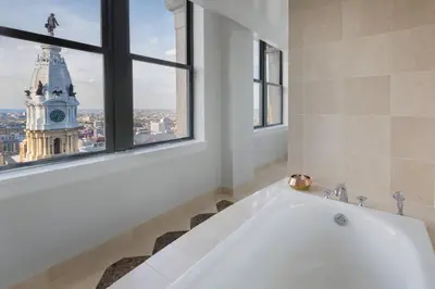 a bath tub in a bathroom with a clock tower at The Ritz-Carlton, Philadelphia in Philadelphia