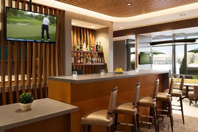 a bar in a restaurant with a television on the wall at SpringHill Suites by Marriott Allentown Bethlehem/Center Valley in Center Valley