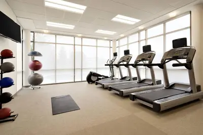 a gym with rows of tread machines in a room at SpringHill Suites by Marriott Allentown Bethlehem/Center Valley in Center Valley