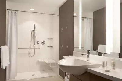 a white bathroom with a sink and a shower at SpringHill Suites by Marriott Allentown Bethlehem/Center Valley in Center Valley