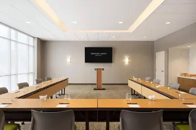 a conference room with tables and chairs and a projection screen at SpringHill Suites by Marriott Allentown Bethlehem/Center Valley in Center Valley