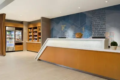 a lobby of a store with a reception counter at SpringHill Suites by Marriott Allentown Bethlehem/Center Valley in Center Valley