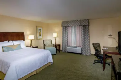 a hotel room with a bed and a desk and chair at Hilton Garden Inn Mount Holly/Westampton in Westampton Township