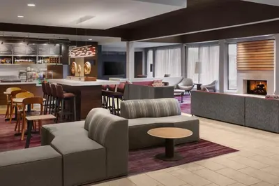 a lobby with couches and chairs and a bar at Courtyard by Marriott Mahwah in Mahwah