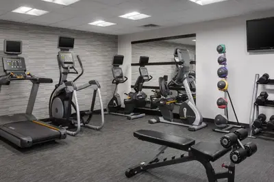 a gym with several treadmills and cardio machines at Courtyard by Marriott Mahwah in Mahwah