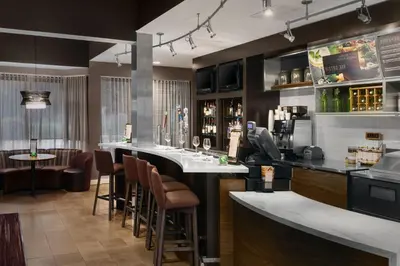 a bar in a restaurant with bar stools at Courtyard by Marriott Mahwah in Mahwah