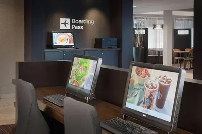 two computers sitting on a table in a restaurant at Sonesta Select Whippany Hanover in Whippany