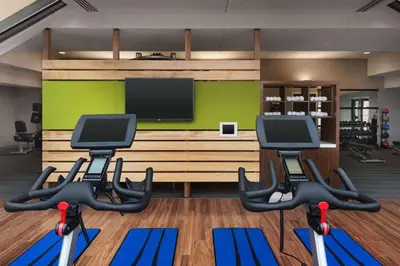 a gym with two exercise bikes and a television at Sonesta Select Whippany Hanover in Whippany