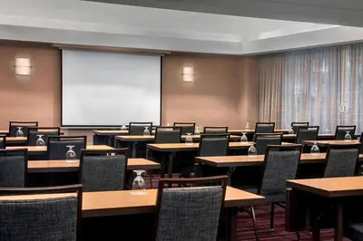 a classroom with tables and chairs and a projection screen at Courtyard By Marriott Jersey City Newport in Jersey City