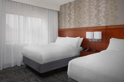 a hotel room with two beds and a window at Courtyard Philadelphia Devon/Villanova in Wayne