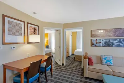 a room with a dining table and a living room at MainStay Suites Mt Laurel - Philadelphia in Mount Laurel