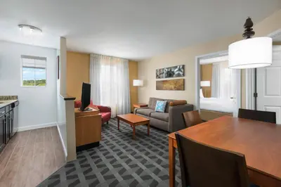 a living room with a dining table and a living room at MainStay Suites Mt Laurel - Philadelphia in Mount Laurel