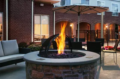 a fire pit in a patio with an umbrella at Residence Inn Philadelphia Willow Grove in Horsham