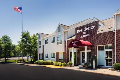 a red brick building with an american flag at Residence Inn Philadelphia Willow Grove in Horsham